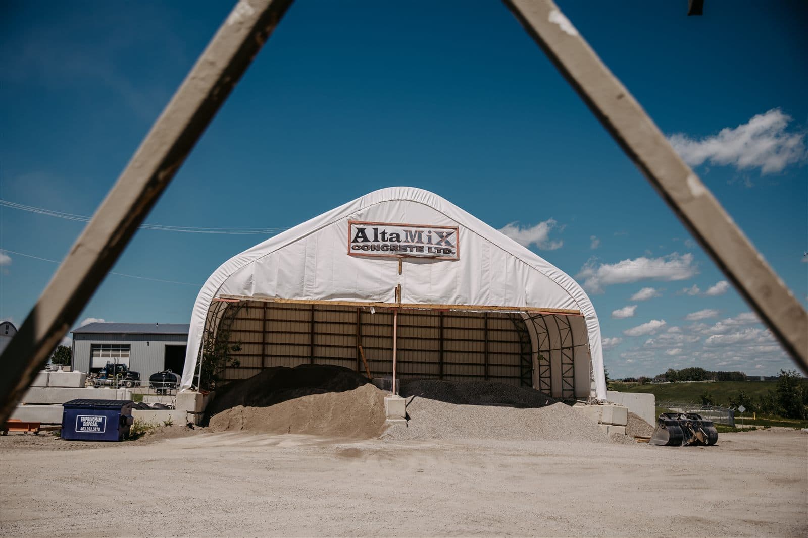 The AltaMix precast yard with the branded aggregate storage dome and loader in Didsbury, Alberta.
